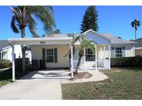 Cute yellow house with carport and small porch at 3211 Lupine Way, Lake Wales, FL 33898