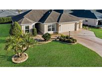 Single-story house with two-car garage and landscaped yard at 1494 Walnut Way, The Villages, FL 32163