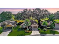 Aerial view of a single-Gathering home with golf course views and lush landscaping at 3240 Hampton Ln, The Villages, FL 32162