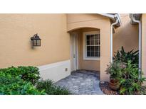 Inviting entryway with brick-paved walkway and landscaping at 41 Camino Real Blvd # 41, Howey In The Hills, FL 34737