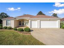 One-story home with two-car garage, landscaping, and a large front yard at 5009 Harbor Hts, Lady Lake, FL 32159