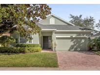 Single-story home with two-car garage and landscaping at 1063 Mesa Verde Ct, Clermont, FL 34711