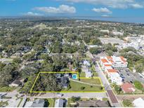 Aerial view of a house with a pool, situated on a large lot in a residential neighborhood at 214 S Woodland St, Winter Garden, FL 34787