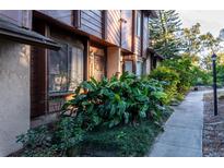 Exterior view of townhome with walkway and lush landscaping at 1015 Love Ln # 33, Apopka, FL 32703