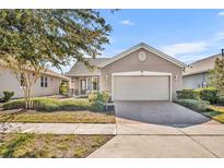 One-story home with a two-car garage and manicured landscaping at 504 Narrow View Ln, Groveland, FL 34736