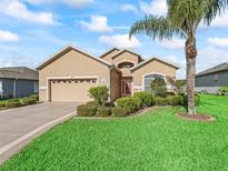 Attractive single-story home with a two-car garage and lush landscaping at 11075 Se 173Rd Pl, Summerfield, FL 34491