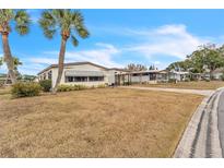 Single-wide manufactured home with carport and spacious yard at 1435 Mohawk Cir, Tavares, FL 32778