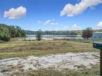 Scenic lakefront lot with a tranquil view, ready for your dream home at 4235 Dove Valley Ln, Lady Lake, FL 32159
