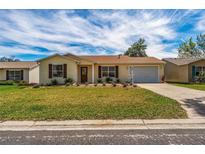 Attractive single-story home with landscaping at 1233 Carvello Dr, The Villages, FL 32162