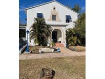 Charming two-story home with unique architectural details and lush landscaping at 100 W Myrtle St, Howey In The Hills, FL 34737