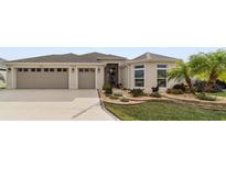 Inviting single-story home with a two-car garage and landscaped front yard at 3766 Causey Ct, The Villages, FL 32163