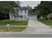 Two-story house with a driveway and yard at 1029 Kirk St, Orlando, FL 32808