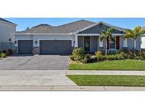 Two-story home with gray siding, red accents, and a lush lawn at 771 Annabell Ridge Rd, Minneola, FL 34715