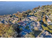 Aerial view of waterfront property with community pool and lake access at 2247 Cypress Cove Dr # E2, Tavares, FL 32778