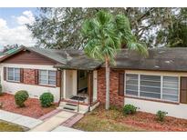 Brick ranch home with palm tree and landscaped yard at 1801 Vine St, Leesburg, FL 34748