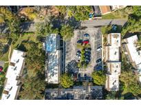 Aerial view of condo community showing building, parking lot, and landscaping at 270 Moree Loop # 5, Winter Springs, FL 32708