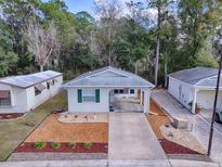 Single-story home with carport and landscaped yard at 32314 Oak Park Dr, Leesburg, FL 34748