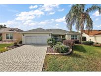 Single-story home with a paved driveway and landscaped yard at 17640 Se 81St Timberwood Ter, The Villages, FL 32162