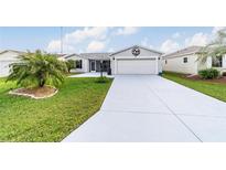 Cute one-story home with a large driveway and palm tree landscaping at 3345 Atwell Ave, The Villages, FL 32162