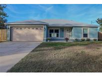 Newly built teal home with attached garage and small front yard at 1761 12Th St, Orange City, FL 32763