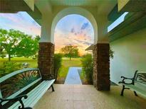 Porch with arched entryway, offering sunset views and seating at 7205 Ne 61St Avenue Rd, Silver Springs, FL 34488