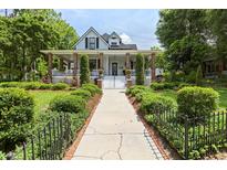 Charming two-story home with a spacious front porch and landscaped yard at 350 E Park Ave, Lake Wales, FL 33853