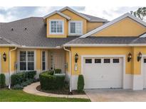 Yellow two-story home with two-car garage and landscaping at 3017 Mission Lakes Dr, Lakeland, FL 33803