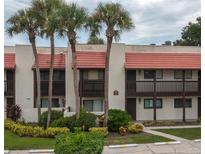 Two-story building with Spanish-style architecture and lush landscaping at 8203 Village Dr # 8203, Lake Wales, FL 33898