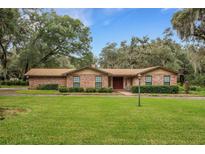 Brick ranch house with landscaped yard at 7510 Catherine Dr, Lakeland, FL 33810