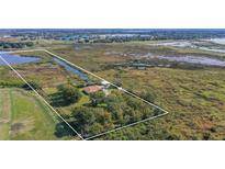 Aerial view of home on secluded lot near lake at 801 Cass Rd, Lake Alfred, FL 33850