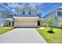 Two story home with light beige garage and landscaping at 1492 Leamington Ln, Winter Haven, FL 33884