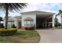 One-story home with covered carport and landscaping at 352 Meandering Way, Polk City, FL 33868