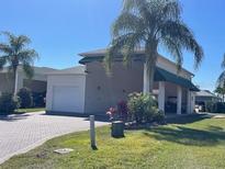 House exterior featuring a carport and landscaping at 336 Motorcoach S Dr, Polk City, FL 33868