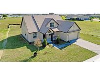 Aerial view of a charming craftsman style home with a large yard at 532 Adams View Ln, Auburndale, FL 33823