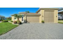 House exterior with a large driveway and attached garage at 360 Motorcoach S Dr, Polk City, FL 33868