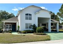 Two-story home with covered carport and landscaping at 1214 Motorcoach Dr, Polk City, FL 33868