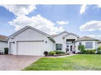 House exterior with a two-car garage at 6265 Pinehurst Loop, Winter Haven, FL 33884