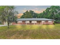 Brick ranch home with spacious lawn and mature trees at 3479 Arrowwood Dr, Lakeland, FL 33811