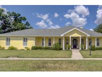 Ranch-style home with gray roof and yellow siding at 745 Square Lake E Dr, Bartow, FL 33830