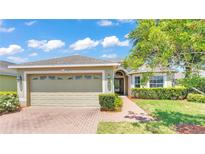 Single story home with attached two-car garage and well manicured landscaping at 3717 Huntington Ln, Winter Haven, FL 33884