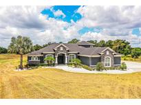 A stunning two-story home with stone accents and a large yard at 2850 Saddle Ridge Ln, Lakeland, FL 33810