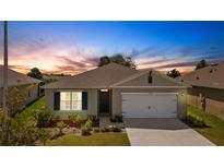 One-story house with a two-car garage and landscaped yard at 5600 Siltstone St, Lakeland, FL 33811