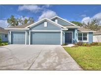 Two-car garage, front yard and driveway of this charming home at 5492 Knights Landing Dr, Lakeland, FL 33810