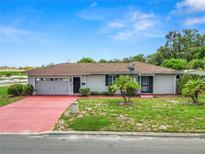 Single-story home with attached garage and landscaped yard at 1342 W Lake Parker Dr, Lakeland, FL 33805