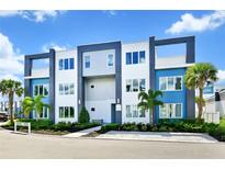 Modern three-story building with blue and white accents at 7770 Sandy Ridge Dr # 115, Reunion, FL 34747