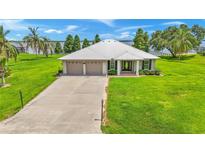 Single-story home with two-car garage and waterfront view at 7884 N Lake Buffum Shores Rd, Fort Meade, FL 33841