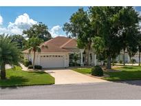 Single-story home with a large driveway and landscaped yard at 6803 Hermitage Dr, Lakeland, FL 33810