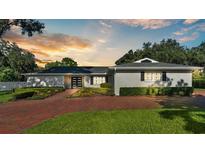 Brick front of a ranch house with a modern door and landscaping at 659 Howard Ave, Lakeland, FL 33815