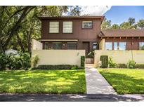 Two-story townhome with brown exterior and landscaped yard at 11 Loma Verde # 11, Lakeland, FL 33813