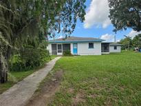 Single-story house with blue trim and large yard at 603 Dixon E St, Fort Meade, FL 33841